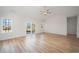 Bright living room with vaulted ceiling, fan, hardwood floors and a sliding glass door to the back yard at 178 Six Mile Creek Dr., Georgetown, SC 29440