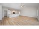 Spacious living room with hardwood floors open to the kitchen and large windows at 178 Six Mile Creek Dr., Georgetown, SC 29440