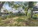 Lush backyard featuring a well-manicured lawn and mature trees, perfect for outdoor activities at 18 Coastal Breeze Trail, Pawleys Island, SC 29585