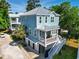 Beautiful two-story blue home featuring an inviting front porch, metal roof, and convenient garage parking at 18 Coastal Breeze Trail, Pawleys Island, SC 29585
