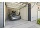 Spacious garage featuring a gray car with a roof rack, providing convenient and secure parking at 18 Coastal Breeze Trail, Pawleys Island, SC 29585