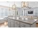 Open-concept kitchen, living, and dining area features a large island with pendant lighting and hardwood floors at 18 Coastal Breeze Trail, Pawleys Island, SC 29585