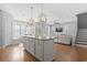 Open-concept kitchen and living area with island, lots of natural light, and hardwood floors at 18 Coastal Breeze Trail, Pawleys Island, SC 29585