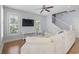 Bright living room features hardwood floors, media center, and windows with shutters, offering both style and privacy at 18 Coastal Breeze Trail, Pawleys Island, SC 29585
