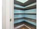 Organized pantry with stained wood shelving and light blue walls to compliment storage at 18 Coastal Breeze Trail, Pawleys Island, SC 29585