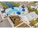 Aerial view of community pool, cabanas, and well-manicured grounds with pond at 1808 Zodiac Court, Myrtle Beach, SC 29577