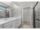 This primary bathroom features a dual vanity with white cabinets and a walk-in shower at 1808 Zodiac Court, Myrtle Beach, SC 29577