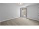 Neutral bedroom featuring plush carpet, soothing lighting, and a bright window at 1808 Zodiac Court, Myrtle Beach, SC 29577