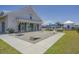 Recreation lawn with cornhole setup in front of a clubhouse with covered patio at 1808 Zodiac Court, Myrtle Beach, SC 29577