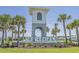 Community entrance tower with waterfall feature and lush tropical landscaping at 1808 Zodiac Court, Myrtle Beach, SC 29577