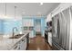 Open kitchen featuring a large island, stainless steel appliances, granite countertops and hardwood flooring at 1808 Zodiac Court, Myrtle Beach, SC 29577