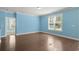 A bright, spacious living room with hardwood floors and a large window at 1808 Zodiac Court, Myrtle Beach, SC 29577