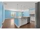 Open-concept living room with hardwood floors, large windows, and access to outdoor patio at 1808 Zodiac Court, Myrtle Beach, SC 29577