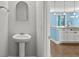 The powder room includes a pedestal sink, mirror, and cabinet storage at 1808 Zodiac Court, Myrtle Beach, SC 29577