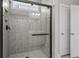 A walk-in shower features elegant tile work, frameless glass, and modern fixtures at 1808 Zodiac Court, Myrtle Beach, SC 29577
