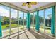 Inviting sunroom with ceiling fan, tile flooring, and panoramic backyard views at 1808 Zodiac Court, Myrtle Beach, SC 29577