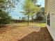 A spacious backyard, featuring a well-maintained lawn and mature trees that offers seclusion and shade at 185 Lander Dr., Conway, SC 29526