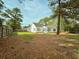 A large backyard with mature trees and a wood fence, offering privacy and space at 185 Lander Dr., Conway, SC 29526