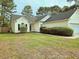 A cozy home with a well-manicured lawn, mature trees, and an attached garage at 185 Lander Dr., Conway, SC 29526