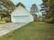 Detached garage with a two-car garage door, grass lawn, and space for garden at 185 Lander Dr., Conway, SC 29526