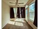 Sun-filled living room featuring a ceiling fan, neutral carpeting, and an abundance of natural light at 185 Lander Dr., Conway, SC 29526