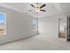 A carpeted bedroom features neutral paint, ceiling fan, and two large windows at 192 Six Mile Creek Dr., Georgetown, SC 29440
