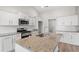 The bright kitchen features a granite island, stainless appliances, and white cabinetry at 192 Six Mile Creek Dr., Georgetown, SC 29440