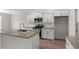 Modern kitchen with granite countertops, white cabinets, stainless steel appliances, and a center island at 192 Six Mile Creek Dr., Georgetown, SC 29440