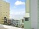 Balcony view showcasing the ocean, nearby buildings, and clear blue skies on a sunny day at 200 53Rd Ave. N # 511, North Myrtle Beach, SC 29582