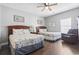 Bedroom with two beds, chair, wood floors, and natural light at 200 53Rd Ave. N # 511, North Myrtle Beach, SC 29582