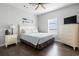 Cozy bedroom features wood floors, dresser, TV, and window at 200 53Rd Ave. N # 511, North Myrtle Beach, SC 29582