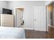 Bedroom with dresser, TV, and doorway to adjacent spaces at 200 53Rd Ave. N # 511, North Myrtle Beach, SC 29582