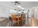 Dining area featuring a long wooden table and chairs, flowing into a modern kitchen with stainless steel appliances at 200 53Rd Ave. N # 511, North Myrtle Beach, SC 29582