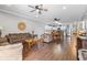Bright, open-concept living area featuring hardwood floors, comfortable seating, and a modern kitchen and dining area at 200 53Rd Ave. N # 511, North Myrtle Beach, SC 29582