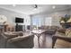 Comfortable living room featuring plush sofas, TV, and balcony access at 200 53Rd Ave. N # 511, North Myrtle Beach, SC 29582