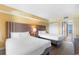 Bedroom featuring two beds, wood-style floors, and closet at 2000 Ocean Blvd. N # Ph11, Myrtle Beach, SC 29577