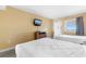 Bright bedroom features two beds, dresser with TV, and a window with scenic views at 2000 Ocean Blvd. N # Ph11, Myrtle Beach, SC 29577