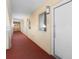 Bright hallway with carpeted floors, doors to multiple units, and a window, creating a welcoming atmosphere for residents at 2000 Ocean Blvd. N # Ph11, Myrtle Beach, SC 29577