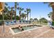Outdoor hot tub surrounded by lounge seating and palm trees at 2000 Ocean Blvd. N # Ph11, Myrtle Beach, SC 29577