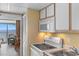 Functional kitchen next to a cozy dining area with ocean views, perfect for enjoying meals with a scenic backdrop at 2000 Ocean Blvd. N # Ph11, Myrtle Beach, SC 29577
