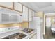 Compact kitchen equipped with standard appliances and storage, designed for efficiency and functionality in a cozy setting at 2000 Ocean Blvd. N # Ph11, Myrtle Beach, SC 29577