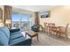 Comfortable living room featuring a sofa, coffee table, balcony access, and ocean views at 2000 Ocean Blvd. N # Ph11, Myrtle Beach, SC 29577