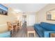 Living room with sofa and dining table, leading to hall and kitchen at 2000 Ocean Blvd. N # Ph11, Myrtle Beach, SC 29577