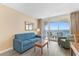 Comfortable living room featuring a sofa, coffee table, balcony access, and ocean views at 2000 Ocean Blvd. N # Ph11, Myrtle Beach, SC 29577