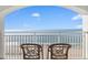 Relaxing seating area with a calming view of the ocean and sandy beach from the balcony at 2000 Ocean Blvd. N # Ph12, Myrtle Beach, SC 29577