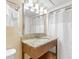 Bright bathroom featuring vanity with granite countertop and a shower with white curtain at 2000 Ocean Blvd. N # Ph12, Myrtle Beach, SC 29577