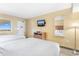 Bright bedroom featuring two beds, a dresser and a window with an ocean view at 2000 Ocean Blvd. N # Ph12, Myrtle Beach, SC 29577