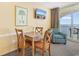 Cozy dining area with table, four chairs, television and ocean views at 2000 Ocean Blvd. N # Ph12, Myrtle Beach, SC 29577
