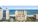 Oceanfront exterior of the building featuring a beachfront view, palm trees, and a parking garage at 2000 Ocean Blvd. N # Ph12, Myrtle Beach, SC 29577