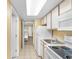 Efficient kitchen with white appliances, cabinets, and countertops near the bedroom at 2000 Ocean Blvd. N # Ph12, Myrtle Beach, SC 29577